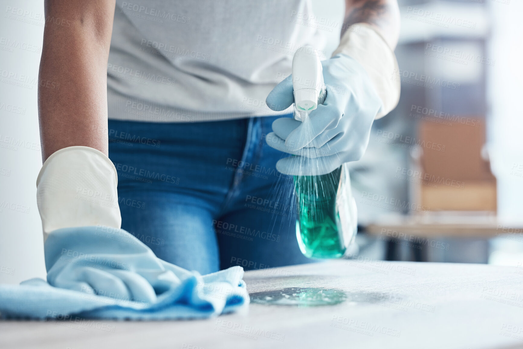 Buy stock photo Hands spray, cleaning service and product for dust on table as cleaner on kitchen counter or dirty home furniture. Hand, worker or janitor wash a messy surface with fresh liquid and cloth with gloves