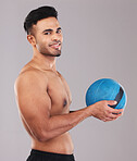 Fitness, topless man with medicine ball and studio portrait with smile on face and gray background. Exercise, gym and health, happy training workout for healthy athlete from Brazil smiling with ball.