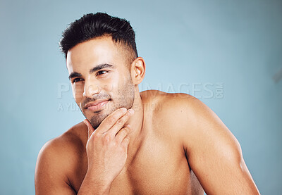 Buy stock photo Skincare, smile and man thinking of health from dermatology against a blue mockup studio background. Wellness, beauty and happy model with idea for healthy body, cosmetics and care with mock up space