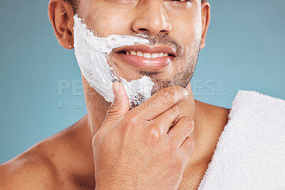 Buy stock photo Man with shaving cream on face, beard maintenance and skincare for mens health and beauty treatment with blue background. Health, skin care and facial hair, morning shave bathroom routine with towel.