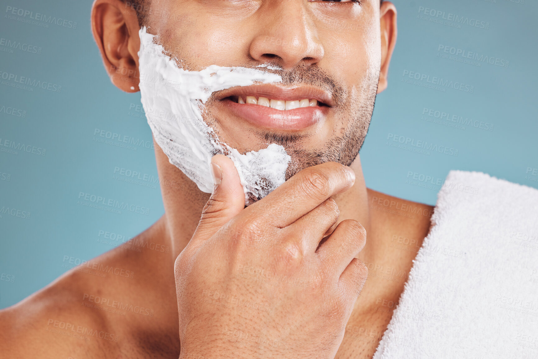 Buy stock photo Man with shaving cream on face, beard maintenance and skincare for mens health and beauty treatment with blue background. Health, skin care and facial hair, morning shave bathroom routine with towel.