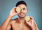 Beauty, man and face, fruit with smile in portrait, grooming and natural cosmetics, skincare advertising with studio background. Indian, citrus and skin with wellness and hygiene, clean and fresh