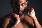 Man, face and blood fist fight with first aid bandages for fighting injury after boxing match. Angry mma athlete boxer, strong bloody hands and fight stand for sports competition in dark background 