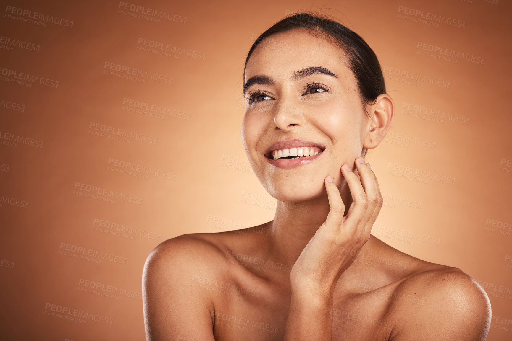 Buy stock photo Thinking, beauty and skincare of hispanic woman against a brown studio background. Clean, smooth face skin of a happy woman after cosmetology and dermatology treatment for health and wellness 