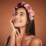 Flower, crown and woman in beauty studio, skincare and wellness while grooming on orange background. Face, rose and girl model smile, relax and happy with floral product, facial and plant aesthetic