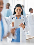 Doctor, tablet and busy hospital with internet research, online schedule and digital calendar at work. Medical worker working in healthcare clinic planning with digital tech to check patient records 