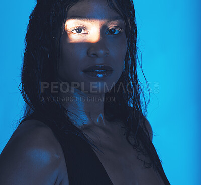 Buy stock photo Beauty, portrait and shadow girl with spotlight for skin health, skincare or cosmetic advertising. Sweaty, edgy and natural cosmetics black woman with blue studio background for marketing.

