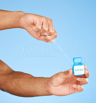 Buy stock photo Floss, dental healthcare and man hands with product container on studio mock up for teeth, mouth and dentist cleaning marketing. Medical, wellness and dental floss health care with blue mockup