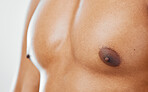 Chest, human body and man in studio to show nipple, anatomy and muscle for health, wellness and fitness of a bodybuilder. Closeup of a model with motivation for exercise, sports training and workout