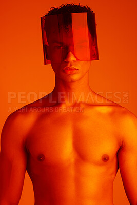 Buy stock photo Body, glasses and red with a man model in studio on a color background for trendy or edgy fashion. Portrait, topless and style with a handsome young male wearing eyewear under bright lighting