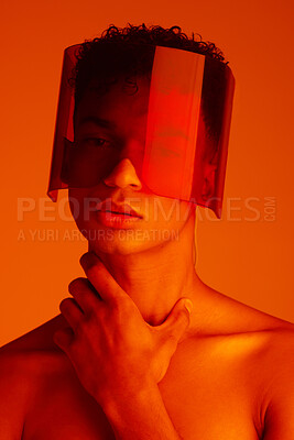 Buy stock photo Orange, futuristic and man with a neon visor for cyberpunk, creative style and art against a studio background. Digital, fashion and face portrait of a model with a designer product for future 