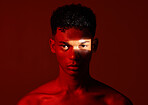 Beauty, red studio and portrait of a man with with a ray of light on his face with a skincare routine. Health, spotlight and model with a wellness skin treatment isolated by a brown background.