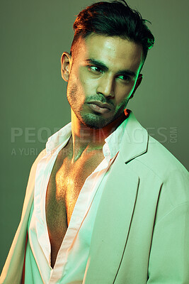 Buy stock photo Green light, fashion and man in studio isolated on a green background. Beauty, neon light and male model from Brazil with idea, thinking or contemplating about cool designer jacket or stylish outfit.