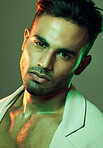 Fashion, green lights and portrait of sexy man from India in studio background creative shoot. Beauty, neon light and professional male model, Indian man and serious face in mens health and cosmetics