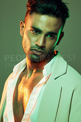 Skincare, wellness and man in studio with neon, green and light for beauty,  health and grooming on a green background. Face, skin and indian model on  creative mockup for product, sexy and