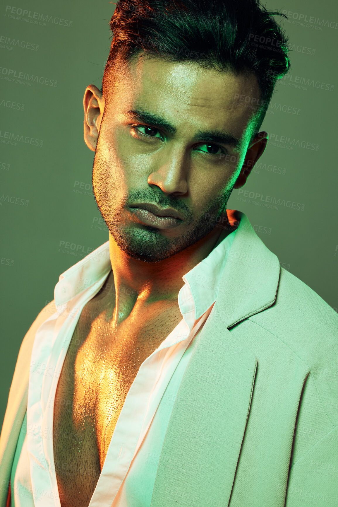 Buy stock photo Skincare, wellness and man in studio with neon, green and light for beauty, health and grooming on a green background. Face, skin and indian model on creative mockup for product, sexy and aesthetic 