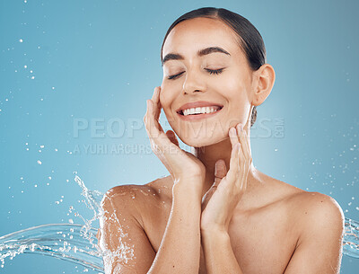 Buy stock photo Woman, beauty and skincare with smile for hygiene, cosmetics or treatment against a blue studio background. Happy female smiling in satisfaction, hydration or care for clean, fresh or perfect skin
