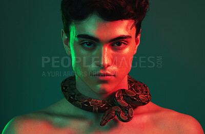 Buy stock photo Snake, beauty and man in studio with green mock up with cosmetics, skincare and lights aesthetic for creative, art and animal print. Neon creativity, natural and nature pet fearless model on mockup