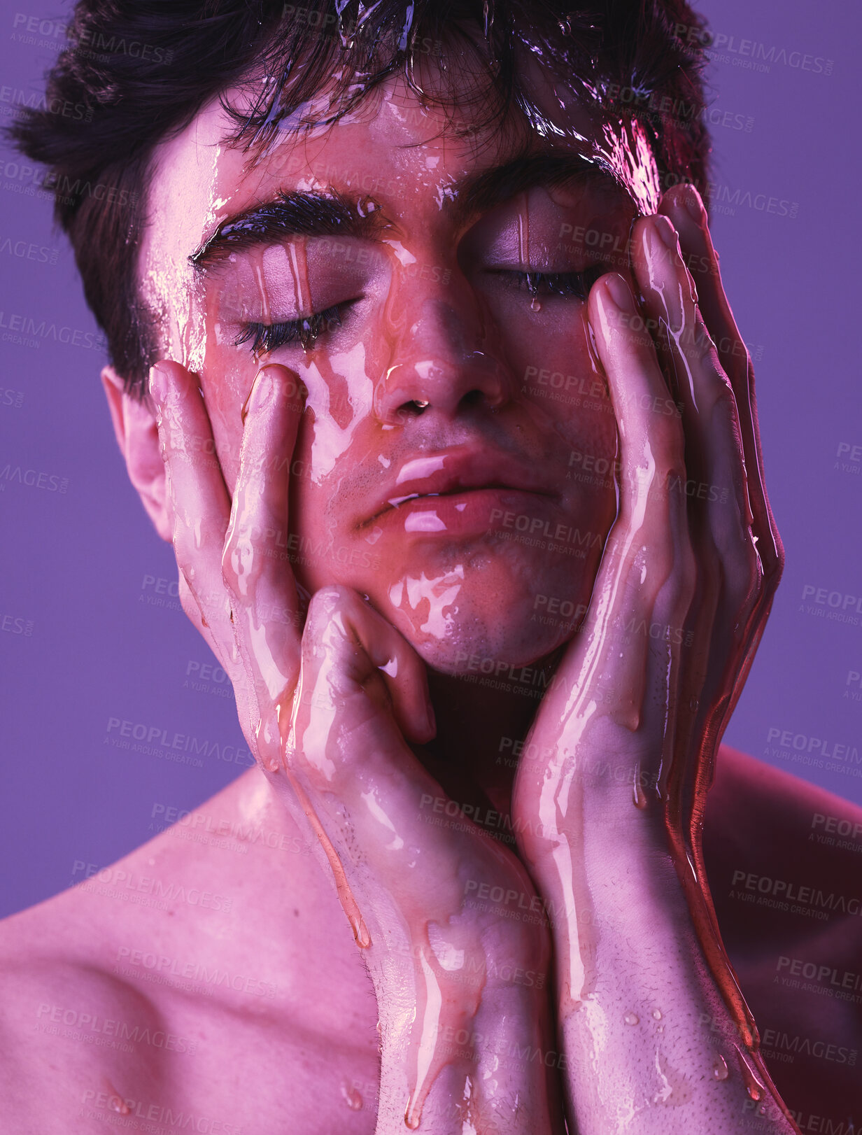 Buy stock photo Model, man and skincare with honey dripping on face, cosmetics and organic beauty by purple backdrop. Skin, cosmetic and facial with natural moisturizer for exfoliate for health, wellness and glow