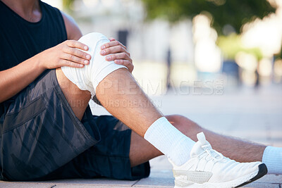 Buy stock photo Knee injury pain, runner or man hurt from fitness, exercise or sports cardio workout for athlete healthcare. Accident emergency, ground floor or legs of training person with medical first aid bandage