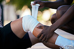 Bandage on legs, injury and pain, sports emergency or accident outdoor with knee sprain, first aid for medical and healthcare. Muscle, joint and wound from exercise, medic and diversity, help injured