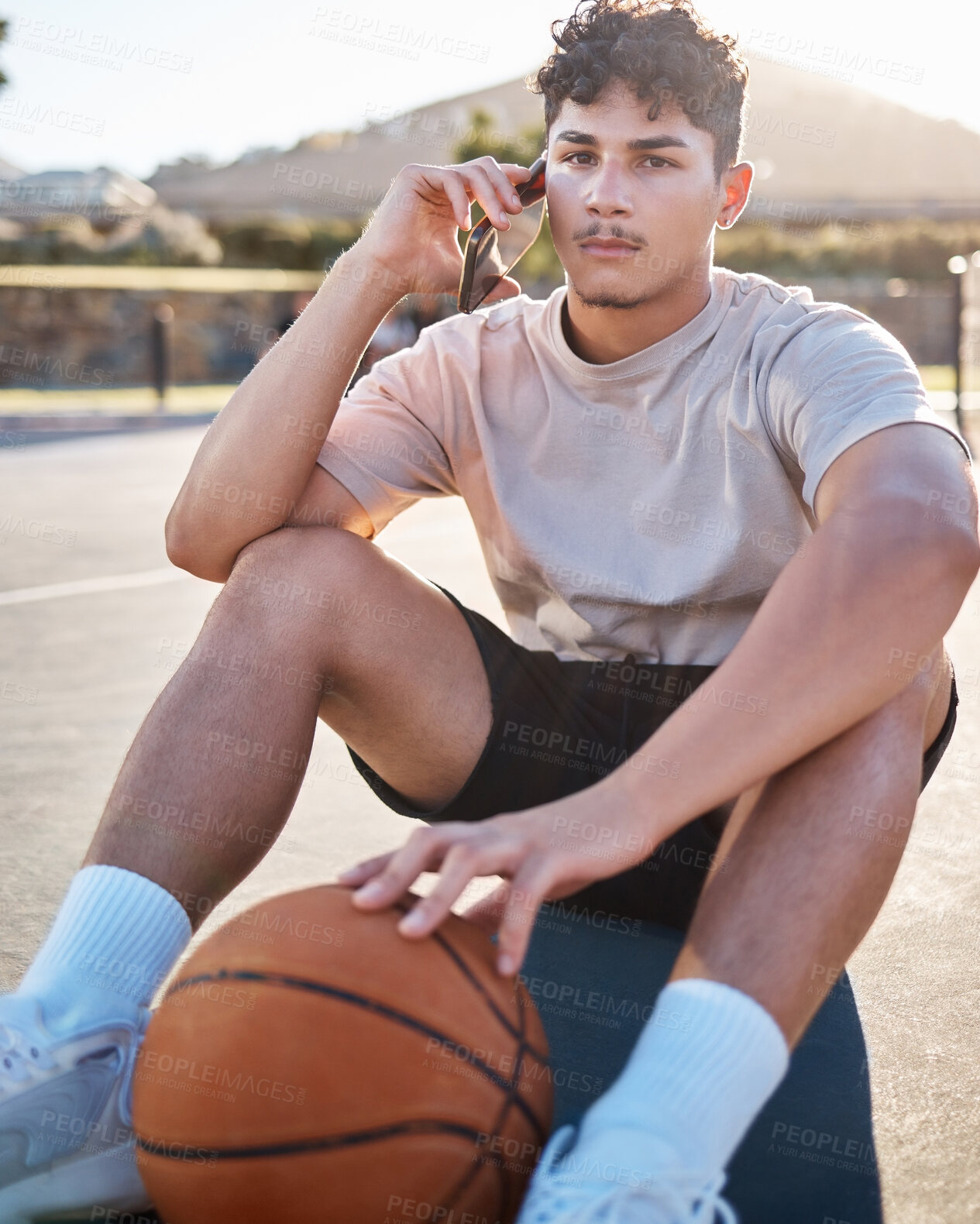 Buy stock photo Basketball player, phone call and relax outdoor on floor talking, networking or communication for training, fitness and sports strategy advice. Basketball teenager on ground with 5g smartphone chat