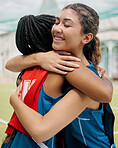 Sport, hug and student girl game match showing support, trust and teamwork on a outdoor field. Student soccer or netball player with a happy smile show diversity and training friendship together