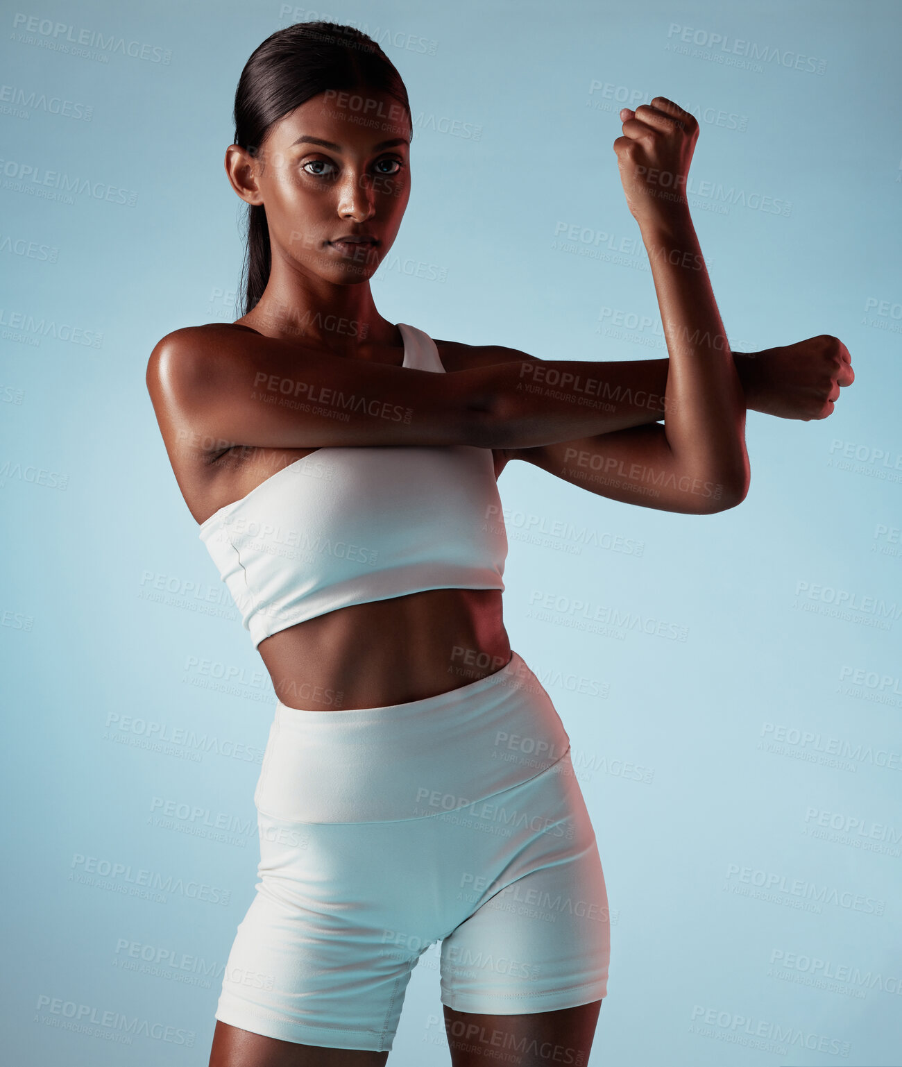 Buy stock photo Fitness, body and stretching black woman in studio for exercise, workout or wellness lifestyle portrait with mock up advertising or marketing. Young sports woman with training fashion on blue mockup