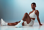 Fitness, woman and portrait in studio for health, exercise and body goals against a blue background mockup. Floor, workout and indian girl model with strong, athletic mindset and sports aesthetic