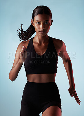 Buy stock photo Fitness, running and energy with portrait of woman training in studio for health, power and endurance. Stamina, sprinting and cardio with runner for sports, workout and exercise in blue background