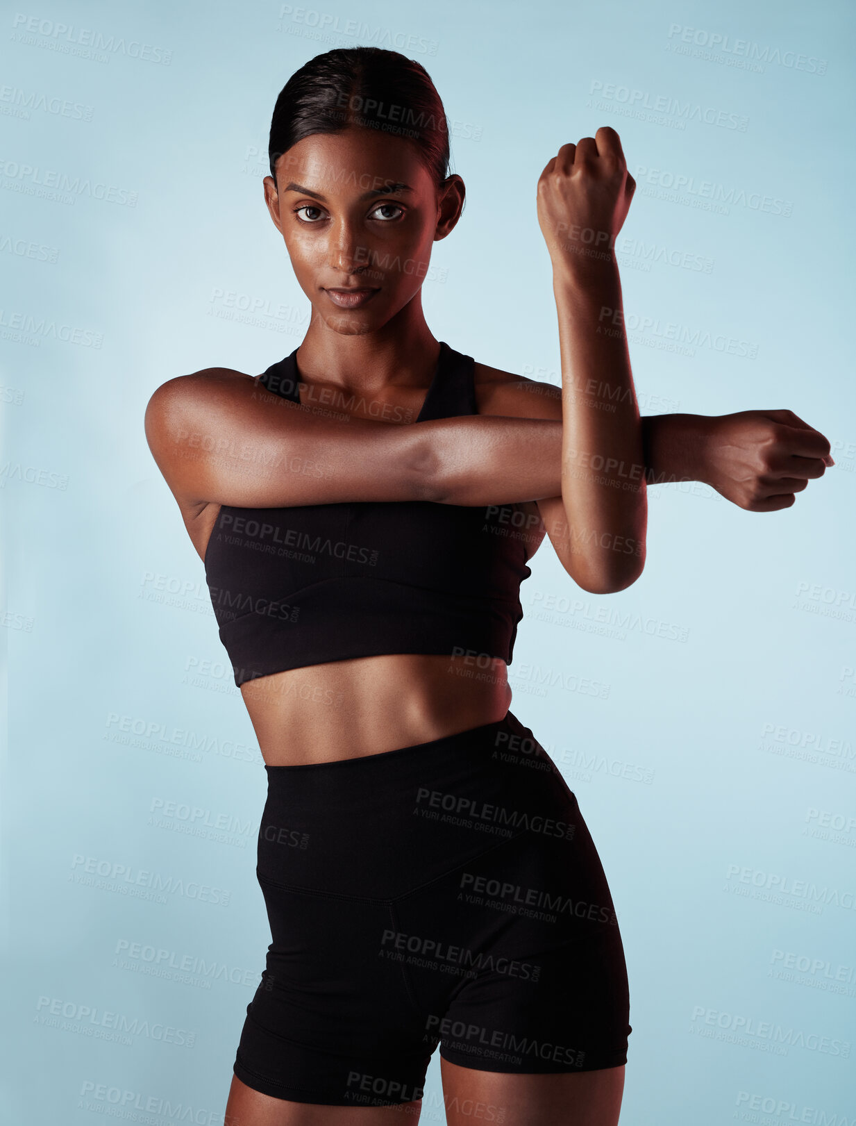 Buy stock photo Woman, fitness or stretching arms on blue background in workout studio, training or exercise. Portrait, model or sports athlete in warmup for health wellness, body performance or muscle power