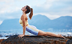 Woman, rock or beach yoga fitness in relax workout, training and exercise in Australia for mental health, wellness or mindset energy. Zen, calm or peace yogi stretching in chakra pilates by ocean sea