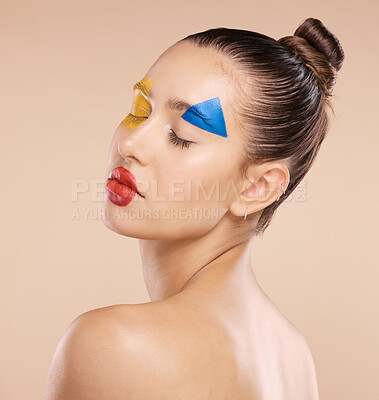 Buy stock photo Woman, beauty and fine art makeup in cosmetics, facial or pose for colorful treatment against a studio background. Beautiful artistic female relaxed in calm satisfaction for creative cosmetic face
