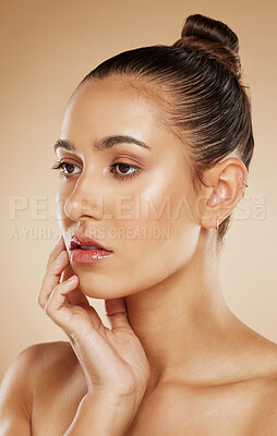 Buy stock photo Beauty, natural and makeup girl thinking with healthy, radiant and cosmetic face touch. Attractive cosmetic model thoughtful feeling glowing skin with beige gradient studio background.

