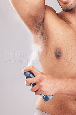 Buy stock photo Man, armpit or underarm deodorant spray on gray studio background for bathroom hygiene, healthcare wellness or fragrance smell. Zoom, hands or model with body odor product in morning grooming routine