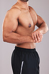 Strong man, bodybuilder and flexing bicep on studio background for fitness, wellness and topless sports workout. Body builder, sexy model and powerful gym athlete proud of big healthy muscle progress