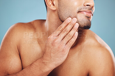 Buy stock photo Man, beard care and hands on face after grooming, fresh and clean shave isolated on blue studio background. Beauty, skincare and wellness of male model, good facial hygiene routine and healthy skin.