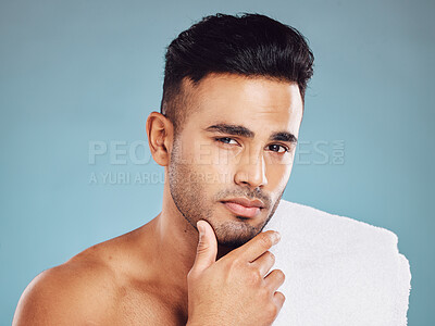 Buy stock photo Man, hand on face and skincare cleaning or grooming cosmetics portrait in studio. Young Indian model, healthy facial care and body skin detox or wellness lifestyle treatment against blue background