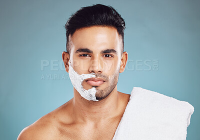 Buy stock photo Shaving, beard and man with cream on his face for skincare against a blue mockup studio background. Wellness, health and portrait of a model with soap or foam to remove facial hair with mock up space