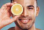 Skincare, lemon and man in face portrait on studio mock up for facial wellness, healthy glow or cosmetics advertising. Young model smile with vitamin c fruit for dermatology product ingredient mockup