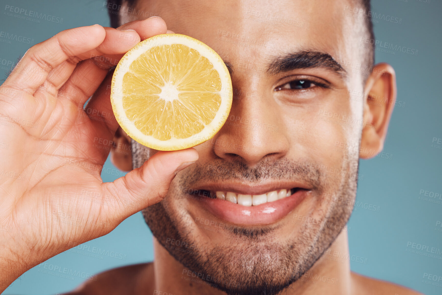 Buy stock photo Skincare, lemon and man in face portrait in a studio for facial wellness, healthy glow or cosmetics advertising. Young  beauty model smile with vitamin c fruit for dermatology product ingredient