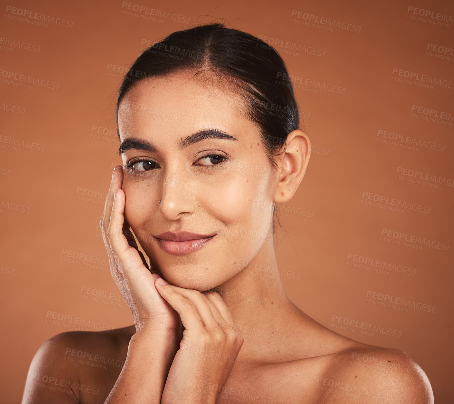 Buy stock photo Skincare, beauty and face of latino woman with makeup, cosmetics and healthy skin. Spa, wellness and young girl pose with hands for dermatology, cosmetology and facial in studio on brown background