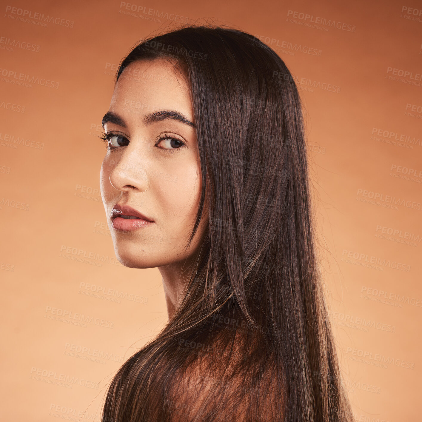 Buy stock photo Hair care, beauty and face portrait of woman on brown studio background. Luxury makeup, skincare and female model with beautiful, healthy and long hair after salon hair treatment for clean hairstyle.