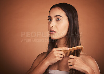 Buy stock photo Beauty, hair and woman with comb in studio with luxury hair care for healthy and clean hairstyle. Health, wellness and grooming, beautiful model girl combing straight hair style on brown background.