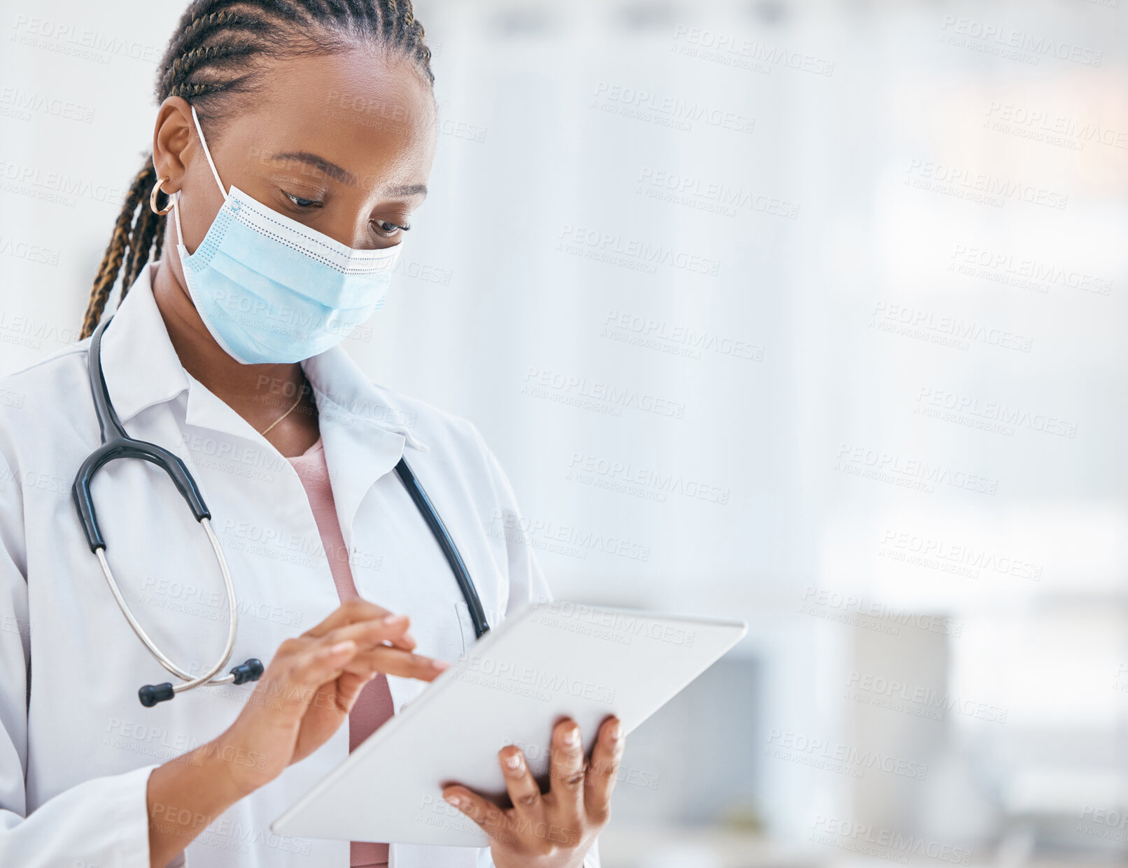 Buy stock photo Doctor, tablet and covid in healthcare research, browsing or scheduling appointment at the hospital. African American medical professional woman or GP checking, test or cure for virus on touchscreen