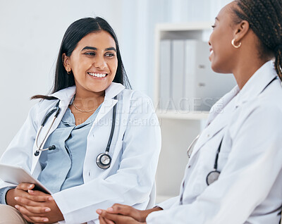 Buy stock photo Diversity, healthcare and doctors talking in hospital, having casual conversation, discussion and chatting. Medical workers, friends and Indian woman with black woman chat, talk and laugh in clinic