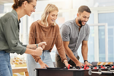 Buy stock photo Business people play foosball table in office for team building competition, staff motivation or happiness in startup. Employees enjoy creative football games for happy teamwork challenge in company 