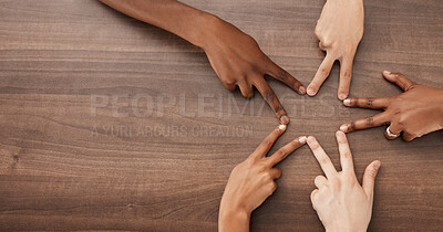 Buy stock photo Hands, diversity and star shape on table for team building, community and peace gesture from above. People, friends or group with collaboration, creativity and teamwork for sign, or icon on a desk