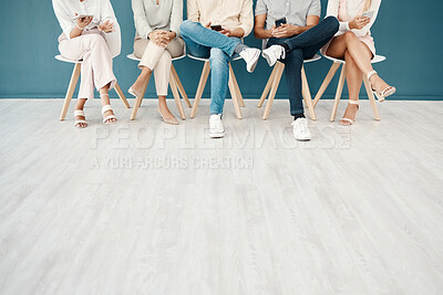 Buy stock photo Feet, team and business people sitting in the office waiting for job interview, presentation and meeting to start. Technology, diversity and group of workers on row of chairs with smartphone in hands