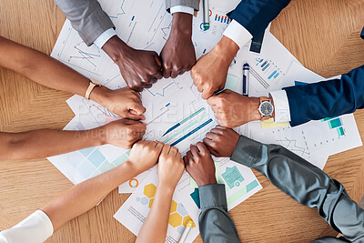 Buy stock photo Teamwork, documents and circle of hands in fist in business meeting for strategy, planning and analytics. Collaboration, diversity and business people with paperwork, infographics and graphs on desk